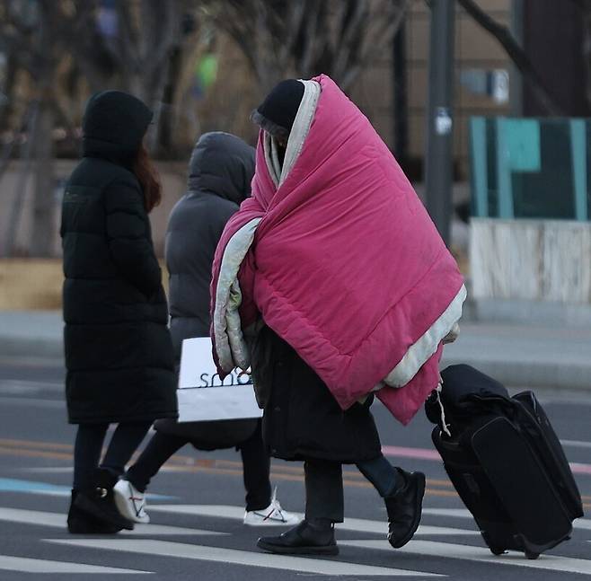 새해 들어 잠시 물러났던 세밑 한파가 돌아왔다. 서울의 아침 최저기온은 11일 영하 9도, 12일 영하 12도까지 내려갈 전망이다. 지난달 31일 오전 서울 광화문사거리에서 시민들이 횡단보도를 건너고 있다. 연합뉴스