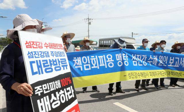 지난해 8월 섬진강댐 하류의 대규모 수해 원인은 섬진강댐의 홍수조절용량 부족과 하천 관리 부실이라는 조사 결과가 발표된 전북 남원시 금지면 온누리센터 앞에서 피해 주민들이 항의 기자회견을 하고 있다. 연합뉴스