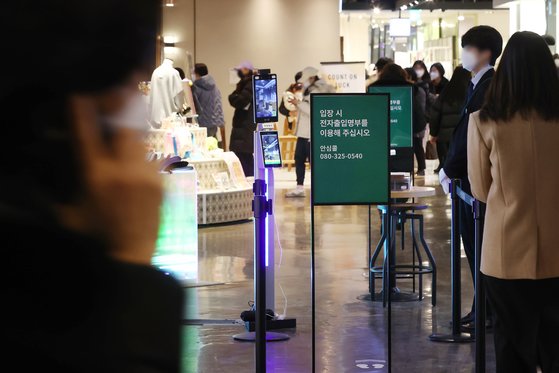 16일 서울의 한 백화점 입구에서 시민들이 QR코드 체크를 하고 있다. [연합뉴스]
