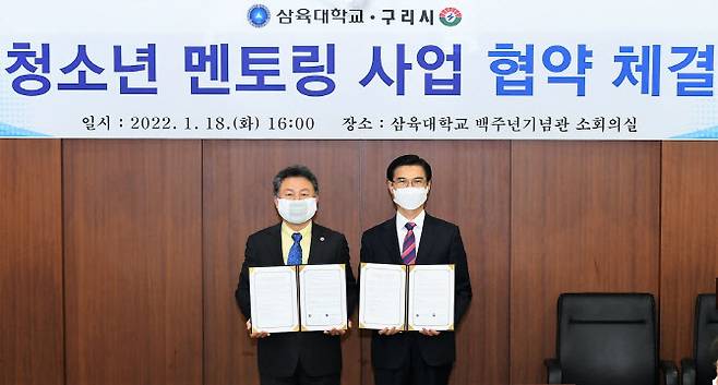안승남 시장(왼쪽)과 김일목 총장이 협약서를 들어보이고 있다.(사진=구리시 제공)