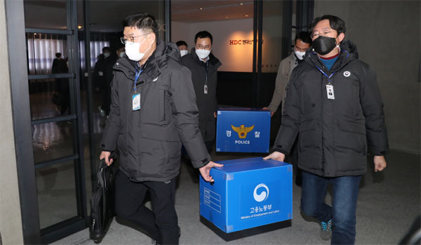19일 고용노동부와 경찰 관계자들이 서울 용산구 HDC현대산업개발 본사에서 합동 압수수색을 벌인 뒤 압수품을 들고 나오고 있다. [이승환 기자]