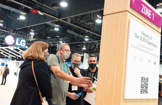 Visitors scan QR codes to find out more about LG Electronics' products during CES 2022. [LG ELECTRONICS]