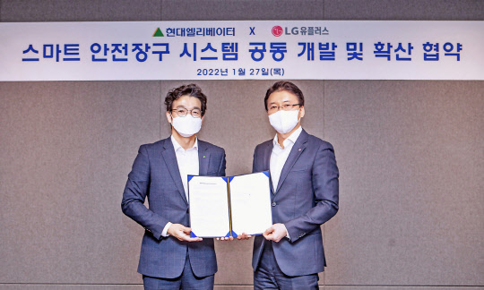 전승훈(오른쪽) LG유플러스 스마트인프라사업담당 상무와 이정한 현대엘리베이터 최고안전환경책임자가 기념 촬영하고 있다. LG유플러스 제공
