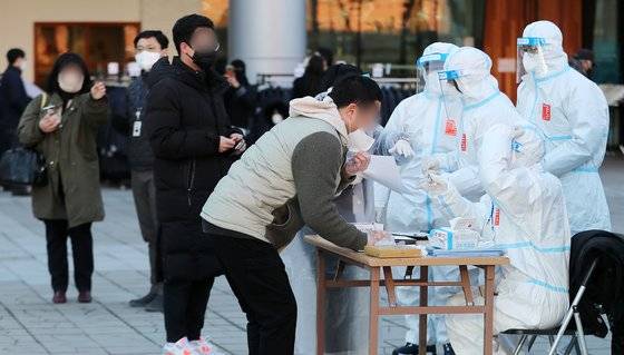 제20대 대통령선거 사전투표 이틀째인 5일 오후 서울역 설치된 남영동 사전투표소에서 코로나19 확진자 및 자가격리자들이 투표에 앞서 신원 확인을 하고 있다. 뉴스1.