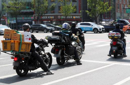 지난 20일 서울 시내 도로에서 배달원이 업무를 하고 있다(사진=뉴시스)