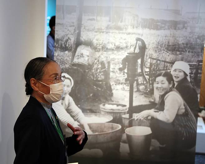 수도가 없었던 우토로 마을 (우토로=연합뉴스) 이세원 특파원 = 다가와 아키코 우토로평화기념관 관장이 27일 일본 교토부 우지시 우토로 마을의 우토로평화기념관에서 우토로 여성들이 재래식 펌프로 물을 길어 빨래하는 모습이 담긴 사진에 관해 설명하고 있다. 우토로에는 1988년에서야 상수도 공사가 시작됐다.