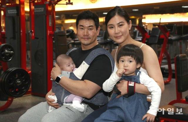 김현정 씨(오른쪽)가 서울 중구 명동 바디플렉스짐에서 남편 하용인 씨와 아이들을 안고 포즈를 취했다. 이훈구 기자 ufo@donga.com