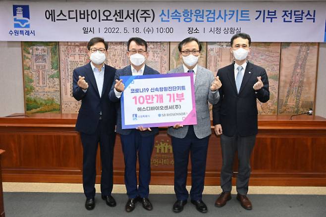 박사승 수원시 경제정책국장(왼쪽부터), 조청식 수원시장 권한대행, 에스디바이오센서 이효근 대표이사, 박성진 상무가 신속항원검사키트 10만 개를 전달받고 이를 기념하고 있다. / 사진제공=수원시