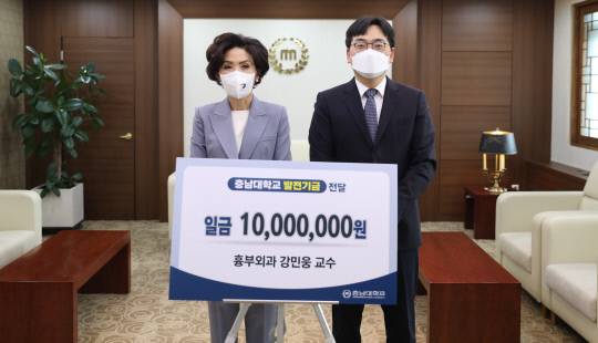 강민웅(오른쪽) 충남대 의과대학 흉부외과 교수가 19일 충남대에 발전기금 1000만 원을 기부하고 이진숙 총장과 기념촬영을 하고 있다. 사진=충남대 제공