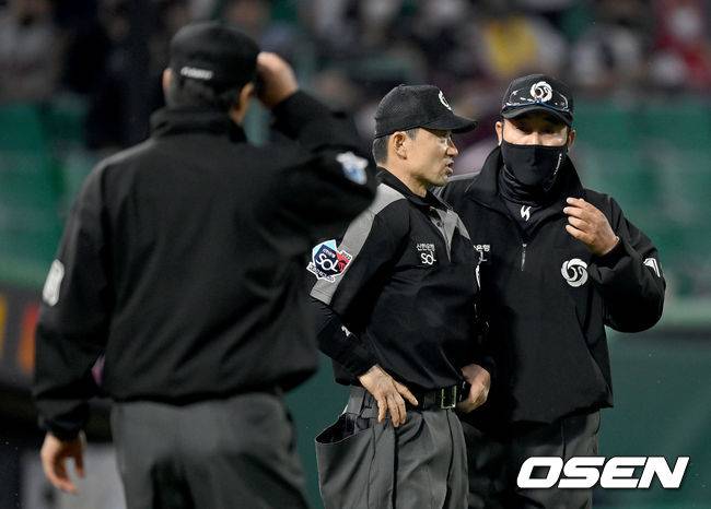 [OSEN=인천, 김성락 기자]9회말 무사 1, 2루 SSG 최지훈이 끝내기 희생플라이 때 LG 3루수 김민식이 타구를 2루로 송구하는 과정에서 실책을 범했다. 이 실책을 틈타 SSG 3루주자 김민식이 홈쇄도해 역전 득점을 올렸다.주심들이 송구실책 관련 비디오판독 판정 논의를 하고 있다. 2022.05.20 /ksl0919@osen.co.kr