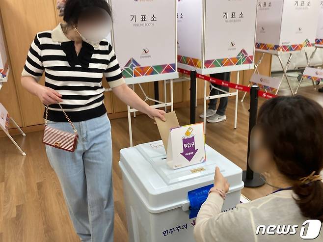 제8회 전국동시지방선거 사전투표 첫날인 27일 오후 부산 영도구청 6층 실내체육관에 마련된 청학제2동 사전투표소에서 한 유권자가 투표함에 투표용지를 넣고 있다.2022.5.27/© 뉴스1 백창훈 기자