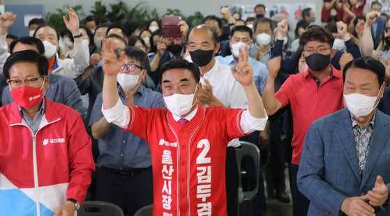 울산시장에 당선된 김두겸 국민의힘 후보가 1일 오후 선거사무소에서 방송 3사 출구조사 결과가 나오자 두 손을 들어 환호하고 있다. 뉴스1