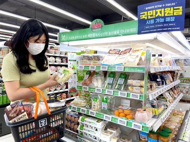 지난해 9월 편의점 세븐일레븐의 신선식품 코너 '세븐팜'에서 한 고객이 콩나물을 들여다보고 있다. 세븐일레븐 제공
