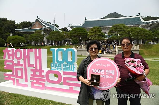 '청와대 100만 번째 관람객 됐어요' (서울=연합뉴스) 22일 오후 청와대 대정원에서 열린 '100만 번째 청와대 관람객' 기념행사에서 100만 번째 관람객으로 선정된 김영순 씨가 기념품으로 받은 대통령 기념 시계를 들고 기념촬영을 하고 있다. 2022.6.22 [문화재청 제공. 재판매 및 DB 금지] photo@yna.co.kr