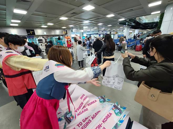 코로나19 사태로 중단됐던 양양국제공항의 국제선 운항이 2년 3개월만인 지난 24일 재개된 가운데 25일 오전 입국한 필리핀 팸투어단 등 관광객에게 기념품이 전달되고 있다. (사진=연합뉴스)