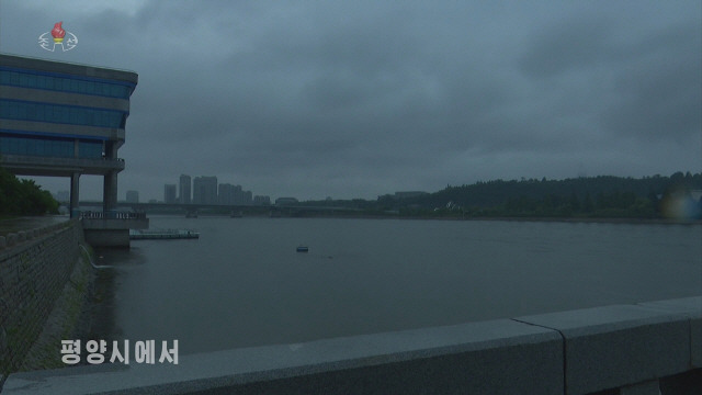 ▲ 북한 기상수문국 실장 독고혁철은 26일 조선중앙TV에 출연해 전날 평양에 쏟아진 폭우로 인한 피해 상황을 설명하고 철저한 대비를 주문했다. 중앙TV가 공개한 사진을 보면 평양 시내 강변에 물이 가득 불어나 있다. [조선중앙TV 화면] 2022.6.26