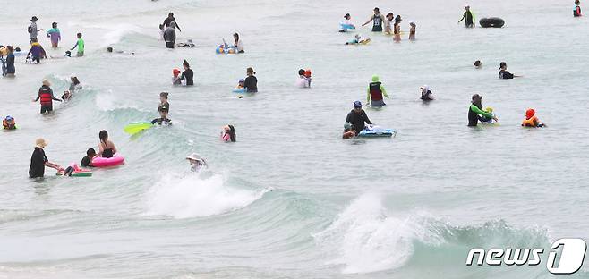 제주 북부와 동부 지역에 폭염주의보가 발효 중인 28일 오후 제주시 함덕해수욕장에서 관광객과 도민들이 물놀이를 즐기고 있다. 2022.6.28/뉴스1 © News1 오현지 기자