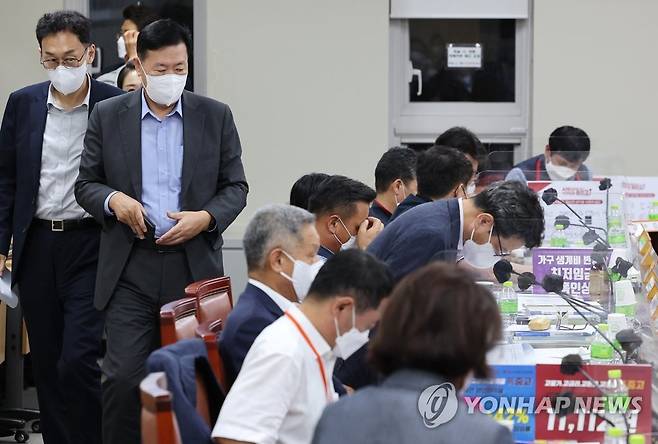 노사 줄다리기 팽팽, 자리로 향하는 류기정 사용자위원 (세종=연합뉴스) 김주형 기자 = 공익위원이 내년도 최저임금을 9천410∼9천860원을 제시한 29일 오후 세종시 정부세종청사 최저임금위원회 회의실에서 열린 제8차 전원회의가 휴정과 개의를 반복하고 있다. 
    사용자위원인 류기정 한국경영자총협회 전무(왼쪽 두번째)를 비롯한 위원들이 회의를 시작하기 위해 자리로 행하고 있다. 2022.6.29 kjhpress@yna.co.kr
