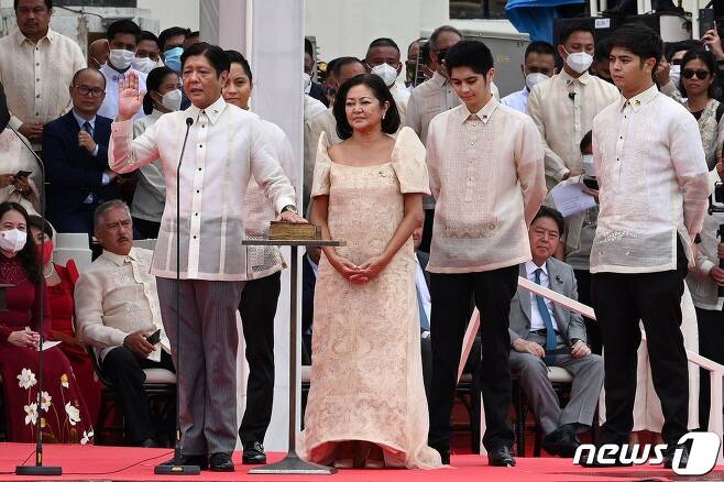 페르디난드 마르코스 주니어(좌측) 필리핀 대통령이 30일 마닐라에 있는 국립박물관에서 열린 취임식에서 취임 선서를 하고 있다. 가운데는 영부인인 루이즈 아라네타 마르코스 여사. © AFP=뉴스1