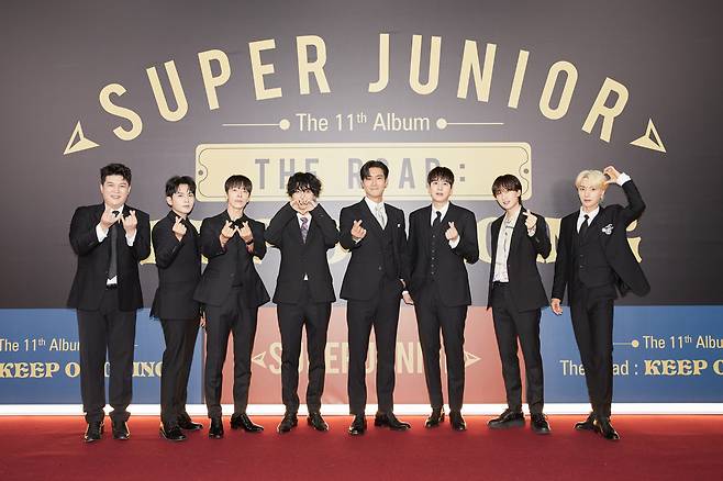 Members of Super Junior pose for photos during an online press conference for the group’s 11th full-length album “Vol.1 ‘The Road: Keep on Going’” on Tuesday. (Label SJ)