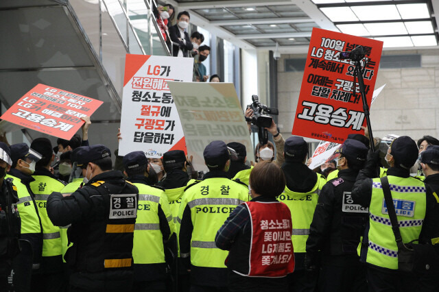 엘지트윈타워에서 해고된 청소노동자들이 지난해 3월26일 오전 서울 여의도 엘지 트윈타워 동관 지하 1층에서 열리는 주주총회장 앞에서 경찰과 경비원들에게 막혀 연좌 농성을 벌이고 있다. 김봉규 선임기자 bong9@hani.co.kr