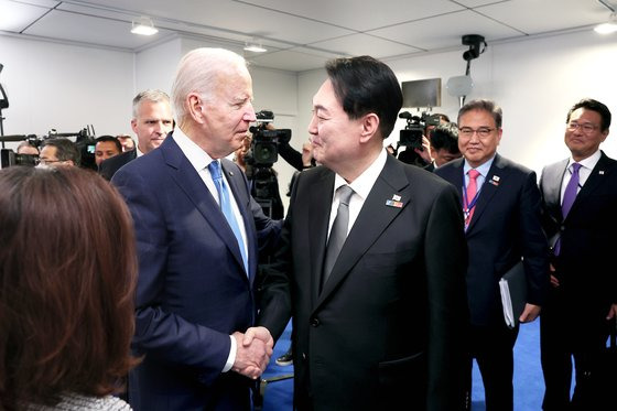 지난 3일 대통령실이 공개한 윤석열 대통령의 북대서양조약기구(NATO) 정상회의 참석 사진. 지난달 29일 스페인 마드리드에서 윤 대통령이 조 바이든 미 대통령을 만나 악수하는 모습. 대통령실. 뉴시스.