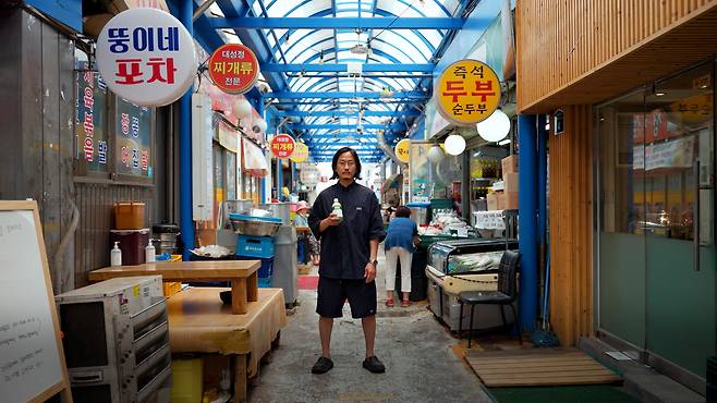 고성용 한강주조 대표가 양조장 근처 뚝도시장에서 표문막걸리를 들고 서있다. /유튜브 '味술관'