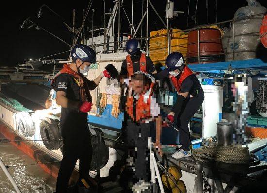 목포 해경이 12일 신안군 재원도 해상에서 심한 복통을 호소한 선원을 이송되고 있다.   사진자료=목포해경