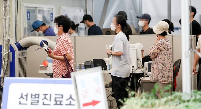 광복절인 15일 오전 서울 송파구보건소에 마련된 코로나19 임시선별진료소를 찾은 시민들이 검사를 기다리고 있다. 연합뉴스.