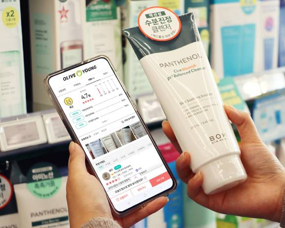 한 고객이 올리브영 모바일 앱(App)에서 상품 리뷰를 확인하는 모습. [사진=CJ올리브영]