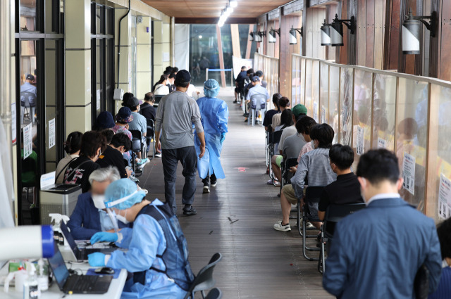 코로나19가 재확산하면서 17일 0시 기준 신규 확진자가 18만 803명에 달하며 18주 만에 최고치를 기록한 이날 오전 서울 송파구 보건소 선별진료소에서 시민들이 검사를 기다리고 있다. 연합뉴스