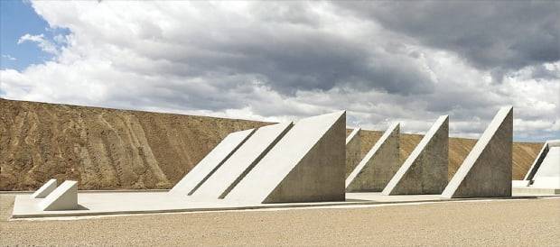 마이클 하이저의 ‘도시’ 속 조형 작품 ‘45도, 90도, 180도’. 삼각형 모양의 반듯한 콘크리트 구조물이 땅에 뾰족한 그림자를 드리우며 환상적인 분위기를 연출한다. 트리플 오트 파운데이션 제공