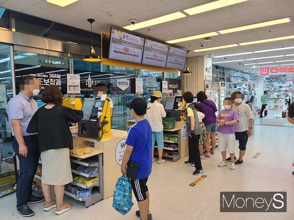 셀프 계산대가 급증했지만 정작 소비자는 장점을 느끼지 못하는 상황이다. 사진은 경기 고양시에 위치한 마트에서 셀프 계산대를 이용하는 소비자와 이들을 도와주는 캐셔의 모습. /사진=서진주 기자