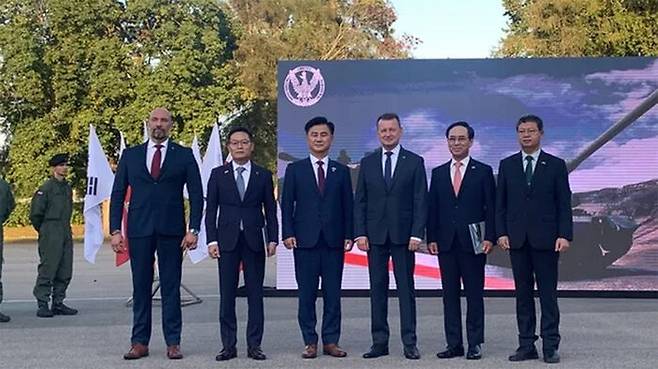 K2와 K9 1차 이행 계약 체결식 직후 폴란드 국방장관, 우리 업체 대표들, 방사청장, 국방부 전력자원실장이 기념촬영을 하고 있다.