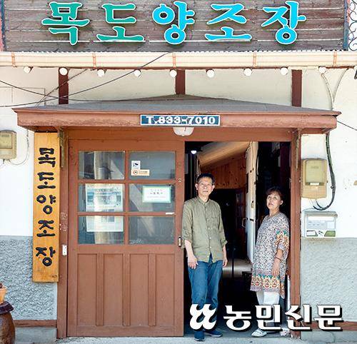 충북도 등록문화재로 지정된 양조장 앞에 선 유기옥 대표(오른쪽)와 남편 이석일씨.