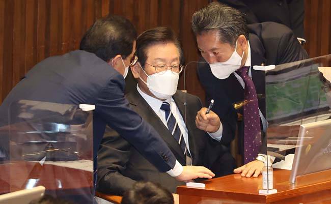 심각한 이재명 : 공직선거법 위반으로 기소 위기에 놓인 이재명 더불어민주당 대표가 7일 오후 국회에서 열린 본회의에 참석해 박홍근(왼쪽 뒷모습) 원내대표와 정청래(오른쪽) 최고위원과 대화를 나누고 있다. 국회사진기자단