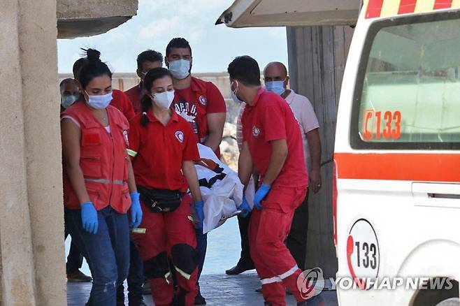 지중해 난민선 침몰사고 현장에서 수습된 시신을 옮기는 시리아 적신월사 구조대원들.  [AFP 연합뉴스 자료사진. 재판매 및 DB 금지]