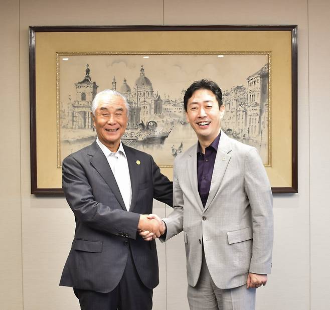 Korea Airports Corp. President and CEO Yoon Hyeong-joon (right) shakes hands with Isao Takashiro, chairman and CEO of Japan Airport Terminal Isao Takashiro, in Tokyo on Monday. (KAC)