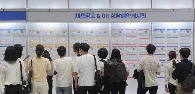 2022 중견기업 일자리 박람회를 찾은 구직자들이 채용공고 게시판을 살펴보고 있다. 연합뉴스