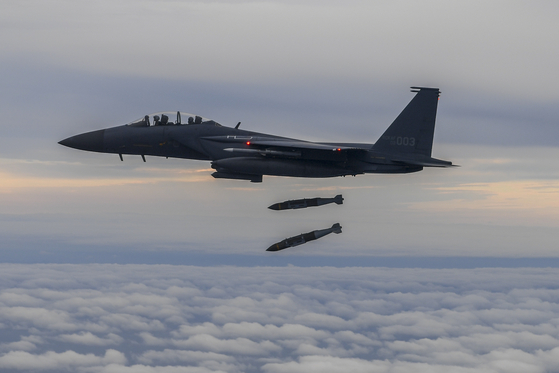 A South Korean F-15K fighter fires two Joint Direct Attack Munition (JDAM) guided bombs at a firing range on the uninhabited island of Jikdo in the Yellow Sea on Tuesday evening in response to the North Korean launch of an intermediate-range ballistic missile (IRBM) that flew over Japan in the morning. [JOINT CHIEFS OF STAFF]