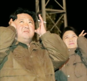 < 이설주 이례적 동행 > 조선중앙통신 등 북한 관영매체들은 김정은 북한 국무위원장과 부인 이설주가 방사포 훈련을 참관하며 귀를 막고 있는 사진을 10일 공개했다.    연합뉴스