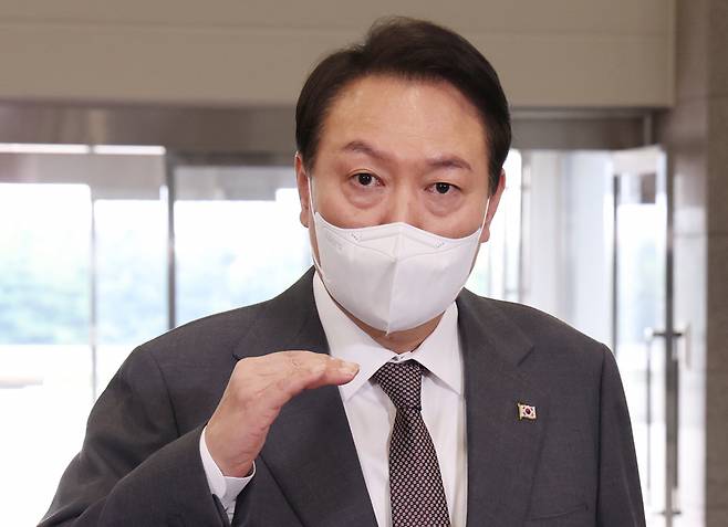 President Yoon Suk-yeol speaks to reporters as he arrives at the presidential office in Seoul on Friday. (Yonhap)