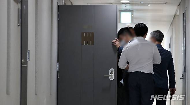 [서울=뉴시스] 김선웅 기자 = 쌍방울그룹의 대북 경제협력 사업을 도와주는 대가로 억대의 뇌물을 수수한 의혹을 받고 있는 이화영 전 경기도 평화부지사에 대한 수사를 중인 검찰이 6일 이 전 부지사가 설립한 동북아평화경제협회에 대한 압수수색에 나섰다. 6일 서울 여의도에 위치한 협회 사무실에서 검찰 관계자들이 압수수색 영장과 관련해 협회 관계자들과 대화를 나누며 진입을 시도하고 있다. 2022.10.06. mangusta@newsis.com