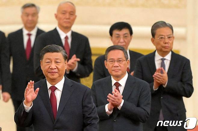 시진핑 중국 국가주석이 23일 (현지시간) 베이징 인민대회당에서 열린 신임 상무위 기자회견장에 리창, 자오러지, 왕후닝, 차이치, 딩쉐샹, 리시 등 새 최고 지도부와 함께 입장을 하고 있다. ⓒ AFP=뉴스1