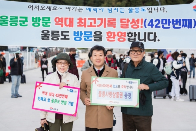 경북 울릉군(군수 남한권·가운데)은 26일 울릉 사동항에서 42만 번째 입도객을 맞이하는 행사를 가진 가운데 관계자들이 기념 촬영을 하고 있다. 울릉군 제공