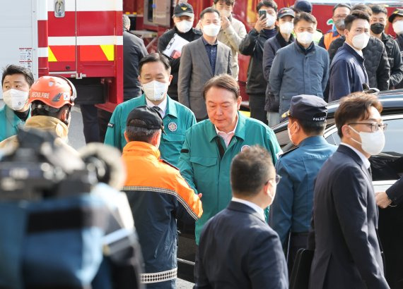 윤석열 대통령이 30일 오전 서울 용산 이태원 참사 현장을 방문한 뒤 관계자들과 인사하고 있다. 연합뉴스