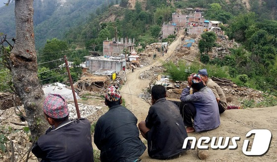 적십자 긴급의료단이 20일 네팔지진 피해 부상자 진료를 위해 방문한 신두팔촉 샤울레 마을에서 주민들이 폐허로 변한 마을을 보고 있다. 마을 인근 산 곳곳에 산사태의 흔적이 역력하다. (본문과 관련없음) 2015.5.21 /뉴스1 ⓒ News1 조희연 기자