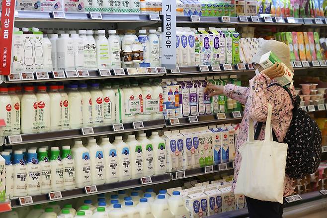 A customer shops for milk at a supermarket in Seoul on Thursday. (Yonhap)