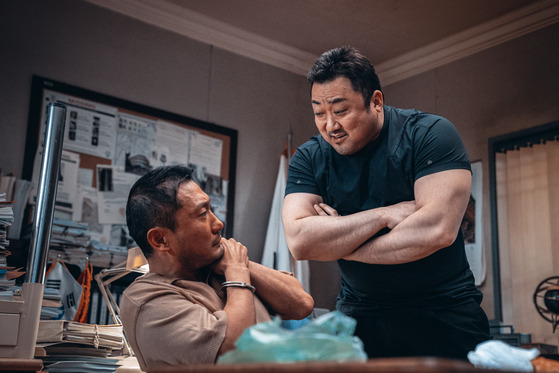 A scene from "The Roundup" (2022), the second and latest release from the "The Outlaws" (2017) franchise. Here shows actors Son Suk-ku, left, and Ma Dong-seok. [ABO ENTERTAINMENT]