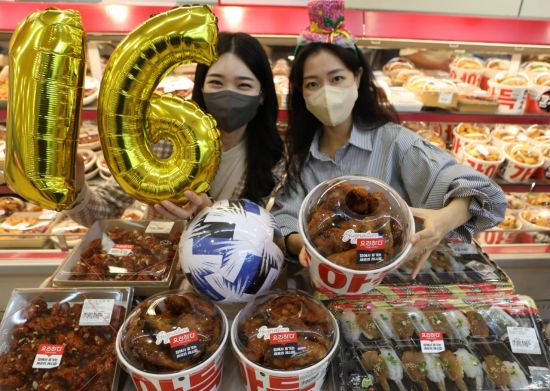 서울 롯데마트 서울역점 델리코너에서 모델들이 '먹거리 행사 상품'을 소개하고 있다. (사진제공=롯데마트)
